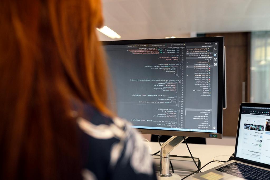 Workspace desk with computer and software applications illustrating digital productivity