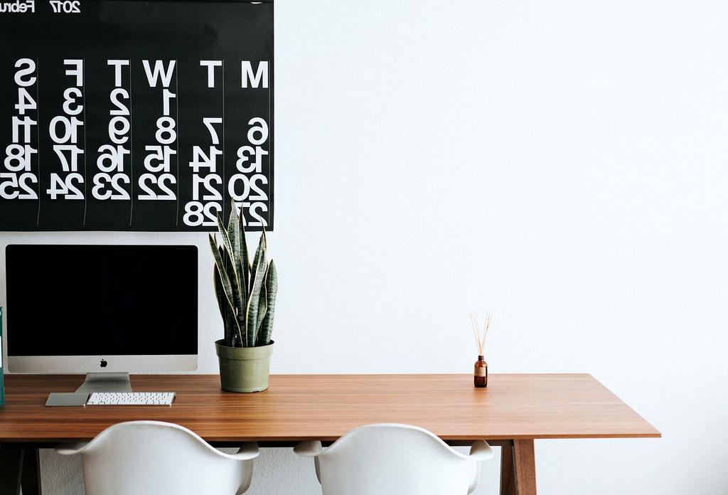 Modern workspace with multiple monitors displaying software applications and productivity tools